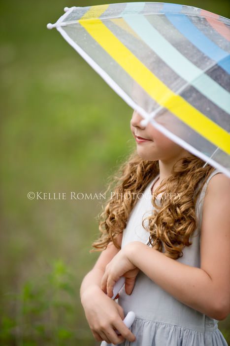 vintage style photo shoot young girl holding colored umbrella outside