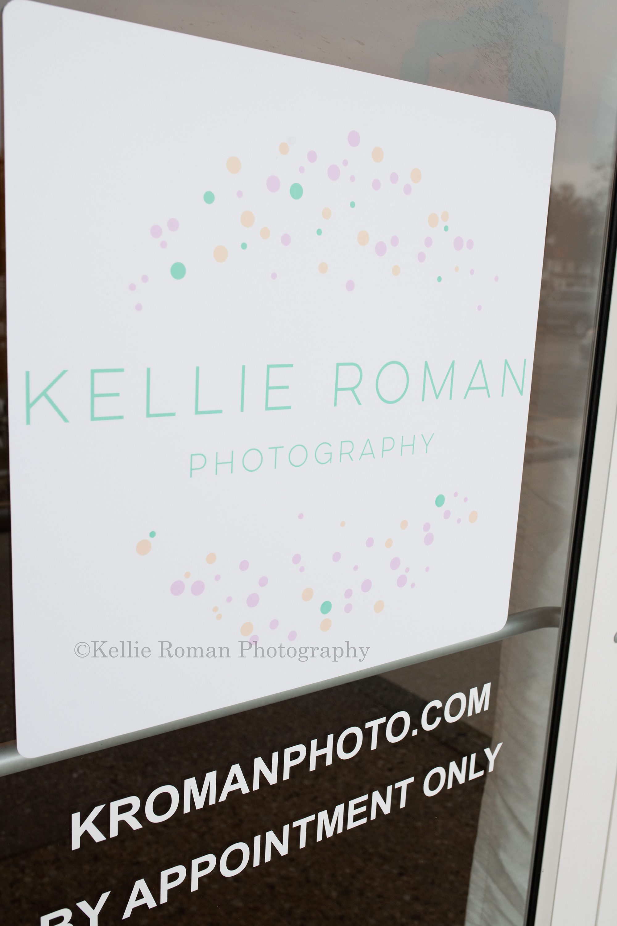 greendale village studio a close up image of a photographers store front located in the historic downtown greendale village the image is of the photographers logo and website